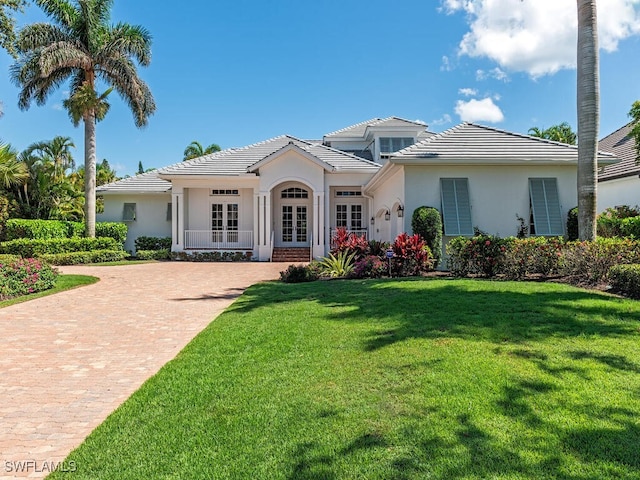 650 Bow Line Dr, Naples, FL 34103 - back of house with french doors, stucco siding, a yard, and a tiled roof