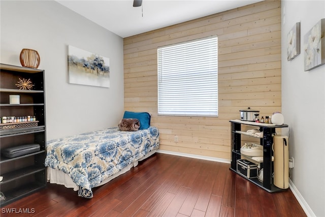 360 3rd St SW, Naples, FL 34117 - bedroom featuring wooden walls, dark wood-type flooring, baseboards, and a ceiling fan