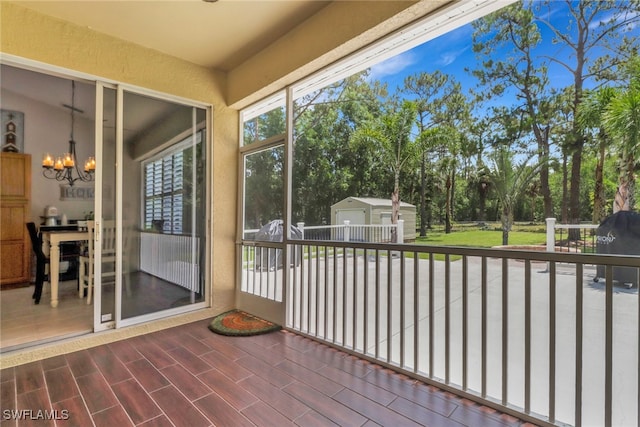 360 3rd St SW, Naples, FL 34117 - unfurnished sunroom with a chandelier and view of scattered trees
