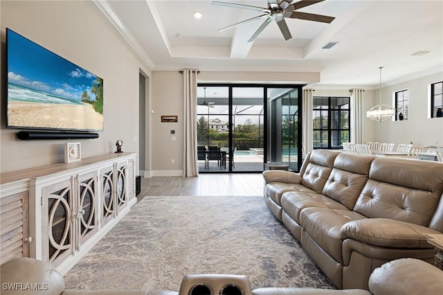 19720 Panther Island Blvd, Estero, FL 33928 - living area with visible vents, crown molding, baseboards, ceiling fan with notable chandelier, and light wood-style floors