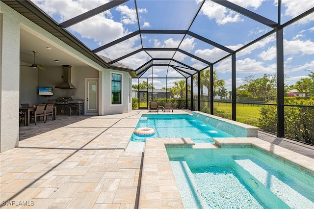 19720 Panther Island Blvd, Estero, FL 33928 - view of pool with ceiling fan, a patio, an outdoor kitchen, a lanai, and a pool with connected hot tub