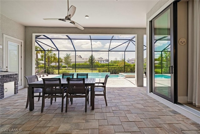 19720 Panther Island Blvd, Estero, FL 33928 - view of patio / terrace featuring glass enclosure, a pool with connected hot tub, a ceiling fan, and outdoor dining area