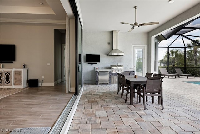 19720 Panther Island Blvd, Estero, FL 33928 - view of patio with area for grilling, a ceiling fan, exterior kitchen, glass enclosure, and outdoor dining space