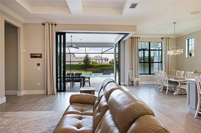 19720 Panther Island Blvd, Estero, FL 33928 - living room featuring visible vents, crown molding, an inviting chandelier, baseboards, and light wood-style flooring