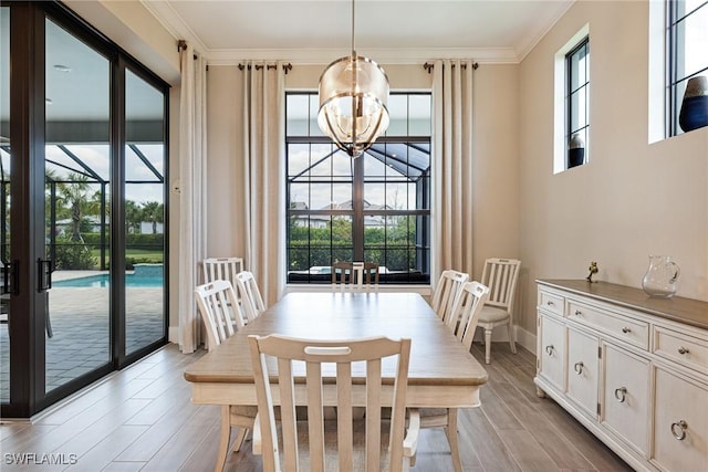19720 Panther Island Blvd, Estero, FL 33928 - dining space with an inviting chandelier, ornamental molding, baseboards, and light wood-type flooring