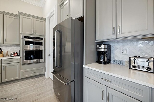 19720 Panther Island Blvd, Estero, FL 33928 - kitchen featuring crown molding, gray cabinetry, and stainless steel appliances