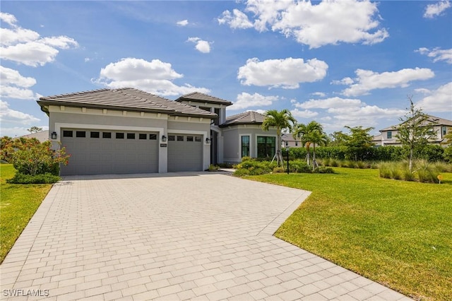 19720 Panther Island Blvd, Estero, FL 33928 - prairie-style house with stucco siding, decorative driveway, a front yard, and a garage