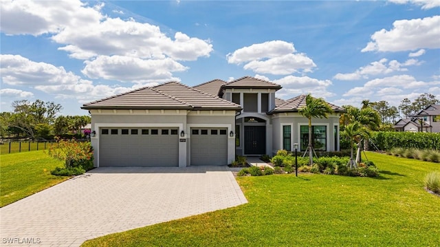 19720 Panther Island Blvd, Estero, FL 33928 - view of front of house featuring a garage, fence, decorative driveway, and a front yard