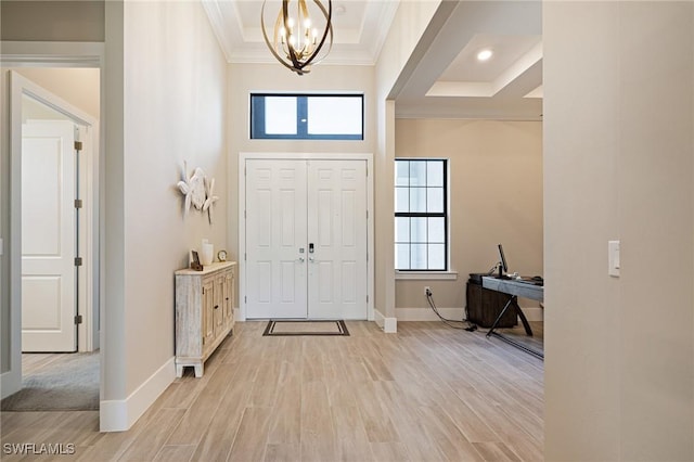 19720 Panther Island Blvd, Estero, FL 33928 - entryway with baseboards, ornamental molding, light wood finished floors, and a chandelier
