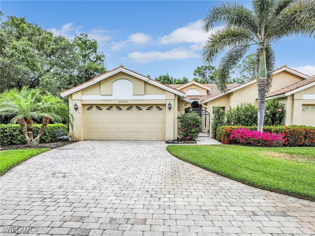 28796 Hunters Ct, Bonita Springs, FL 34135 - ranch-style house featuring a garage, a front lawn, decorative driveway, stucco siding, and a gate