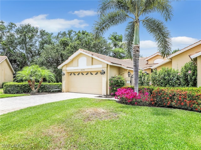 28796 Hunters Ct, Bonita Springs, FL 34135 - ranch-style home featuring a tile roof, a front lawn, a garage, stucco siding, and driveway
