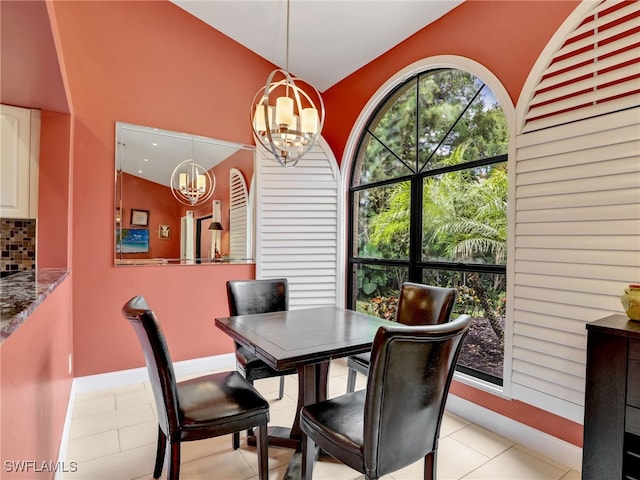 28796 Hunters Ct, Bonita Springs, FL 34135 - dining room with baseboards, a notable chandelier, light tile patterned flooring, and vaulted ceiling