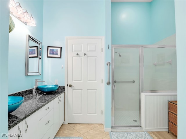 28796 Hunters Ct, Bonita Springs, FL 34135 - bathroom with a sink, double vanity, tile patterned floors, baseboards, and a shower stall