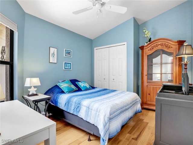 28796 Hunters Ct, Bonita Springs, FL 34135 - bedroom with multiple windows, a ceiling fan, vaulted ceiling, a closet, and light wood finished floors