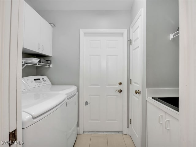 28796 Hunters Ct, Bonita Springs, FL 34135 - washroom featuring cabinet space, light tile patterned flooring, and washing machine and clothes dryer