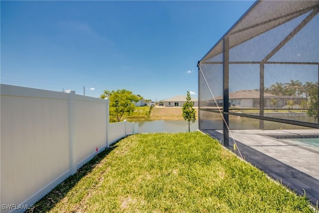 10 NW 13th Pl, Cape Coral, FL 33993 - view of yard with glass enclosure, a water view, and fence