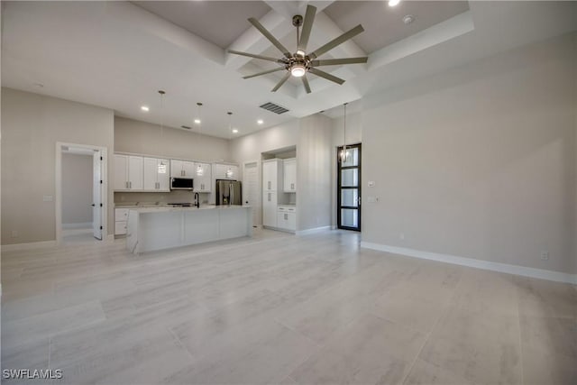 10 NW 13th Pl, Cape Coral, FL 33993 - unfurnished living room featuring visible vents, beam ceiling, baseboards, a ceiling fan, and coffered ceiling