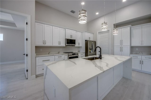 10 NW 13th Pl, Cape Coral, FL 33993 - kitchen featuring visible vents, a large island, white cabinets, a sink, and stainless steel appliances