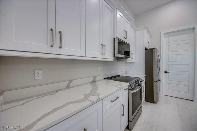 10 NW 13th Pl, Cape Coral, FL 33993 - kitchen with light stone counters, white cabinets, and stainless steel appliances