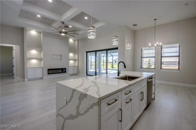 10 NW 13th Pl, Cape Coral, FL 33993 - kitchen with a sink, ceiling fan with notable chandelier, baseboards, stainless steel dishwasher, and a center island with sink