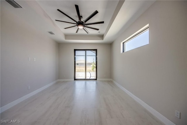 10 NW 13th Pl, Cape Coral, FL 33993 - spare room featuring visible vents, baseboards, ceiling fan, and a tray ceiling