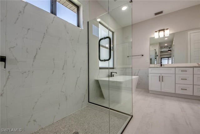 10 NW 13th Pl, Cape Coral, FL 33993 - bathroom featuring visible vents, an enclosed shower, tile walls, a freestanding bath, and vanity