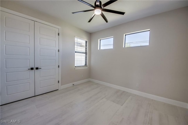 10 NW 13th Pl, Cape Coral, FL 33993 - unfurnished bedroom with baseboards, ceiling fan, and a closet