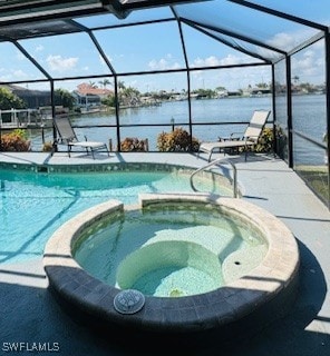 717 SW 49th Ln, Cape Coral, FL 33914 - view of swimming pool with a pool with connected hot tub, a water view, and glass enclosure