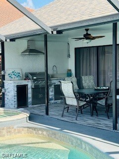 717 SW 49th Ln, Cape Coral, FL 33914 - view of patio / terrace with exterior kitchen, an outdoor pool, ceiling fan, and an in-ground hot tub