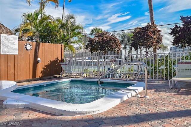 view of swimming pool featuring fence and a pool