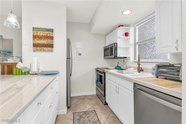kitchen featuring a sink, appliances with stainless steel finishes, white cabinetry, and light countertops
