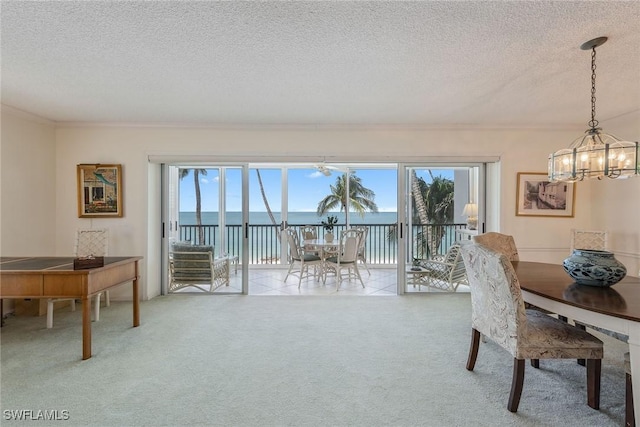 1275 Gulf Shore Blvd N Unit 301, Naples, FL 34102 - carpeted dining space with plenty of natural light, a textured ceiling, crown molding, and a notable chandelier