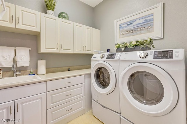 laundry room featuring a sink, cabinet space, and independent washer and dryer