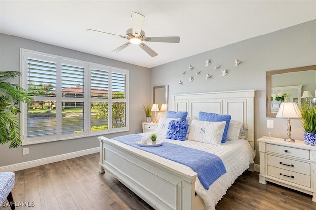 bedroom with baseboards, dark wood-style flooring, and ceiling fan
