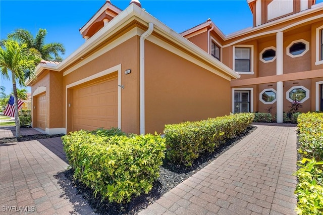 exterior space featuring a garage and stucco siding