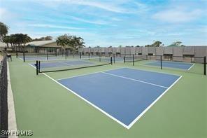 view of tennis court featuring community basketball court and fence