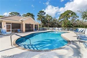 community pool featuring a patio area and fence