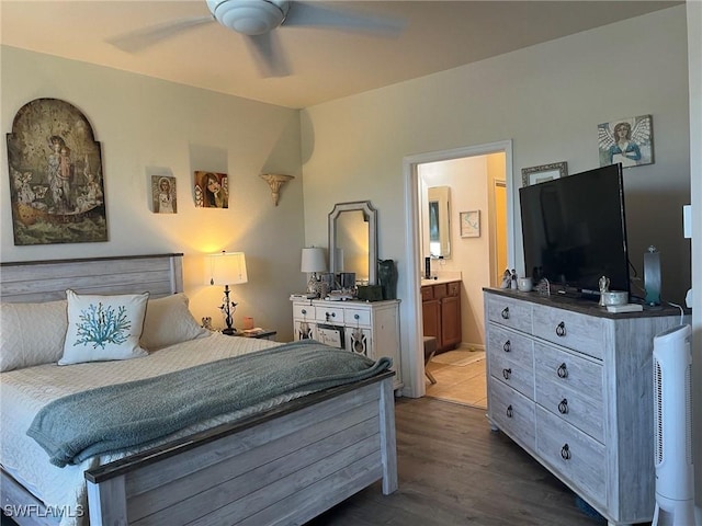 bedroom with dark wood-style flooring, ensuite bath, and ceiling fan