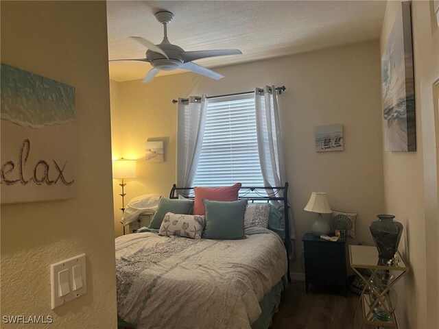 bedroom with wood finished floors and a ceiling fan