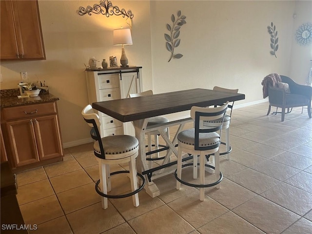 9631 Spanish Moss Way Unit 3931, Bonita Springs, FL 34135 - dining area featuring baseboards and light tile patterned floors