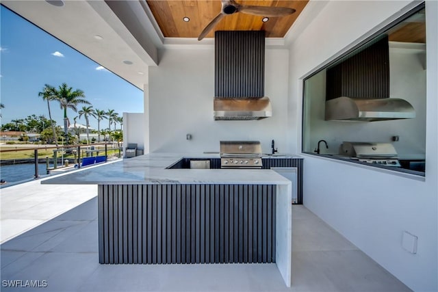 view of patio featuring area for grilling, grilling area, and a ceiling fan