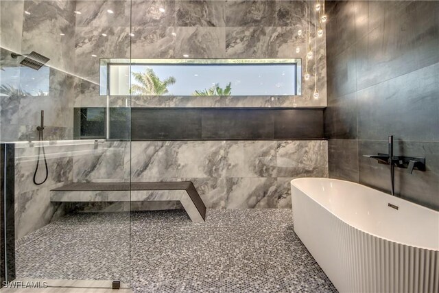 full bathroom with tile walls, walk in shower, and a freestanding bath