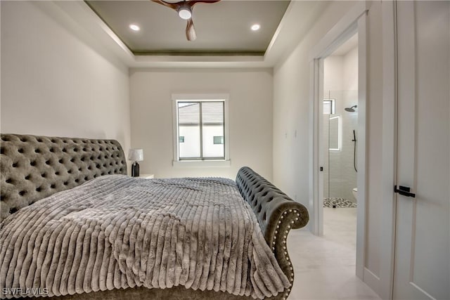 bedroom with recessed lighting and a tray ceiling