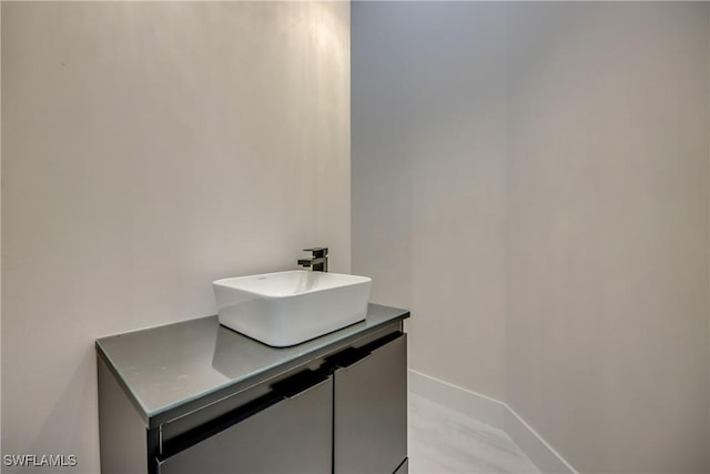 bathroom with vanity and baseboards