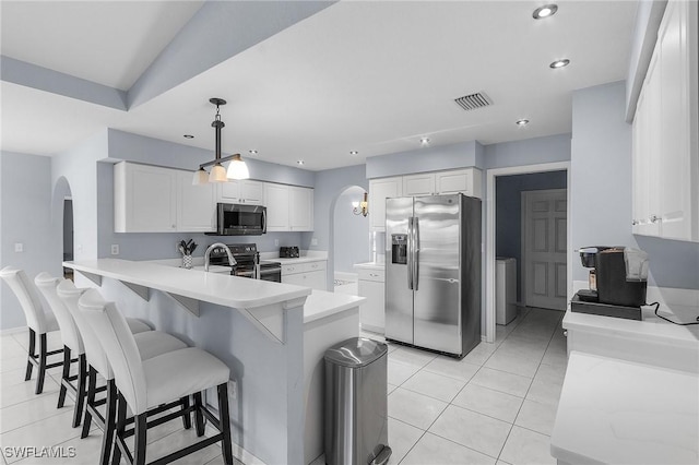 4004 Chiquita Blvd S, Cape Coral, FL 33914 - kitchen with arched walkways, a breakfast bar, stainless steel appliances, white cabinetry, and visible vents