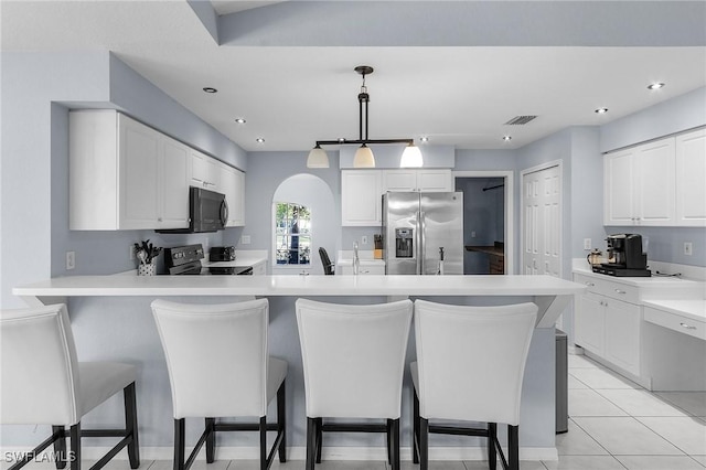 4004 Chiquita Blvd S, Cape Coral, FL 33914 - kitchen featuring stainless steel appliances, a kitchen bar, a peninsula, white cabinetry, and light countertops