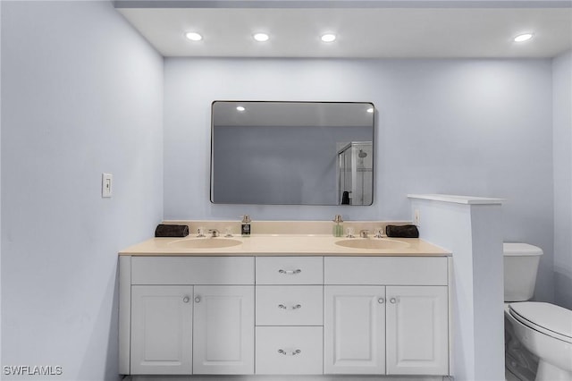 4004 Chiquita Blvd S, Cape Coral, FL 33914 - bathroom with a stall shower, toilet, double vanity, and a sink