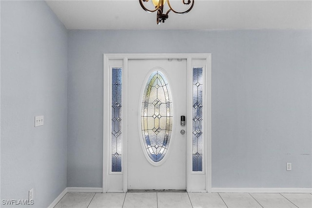 4004 Chiquita Blvd S, Cape Coral, FL 33914 - foyer featuring baseboards, light tile patterned floors, and a notable chandelier