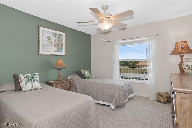 bedroom with carpet floors, baseboards, and a ceiling fan