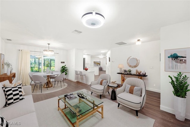 6012 Perthshire Ln, Fort Myers, FL 33908 - living area with wood finished floors, baseboards, and a chandelier